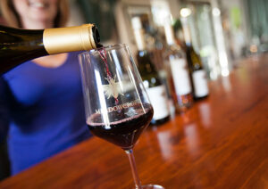 Woman pouring red wine into glass