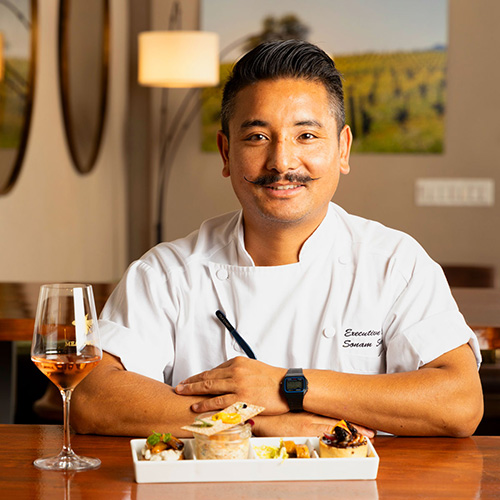 Chef Sonam Sherpa with Taste of Meadowcroft dishes